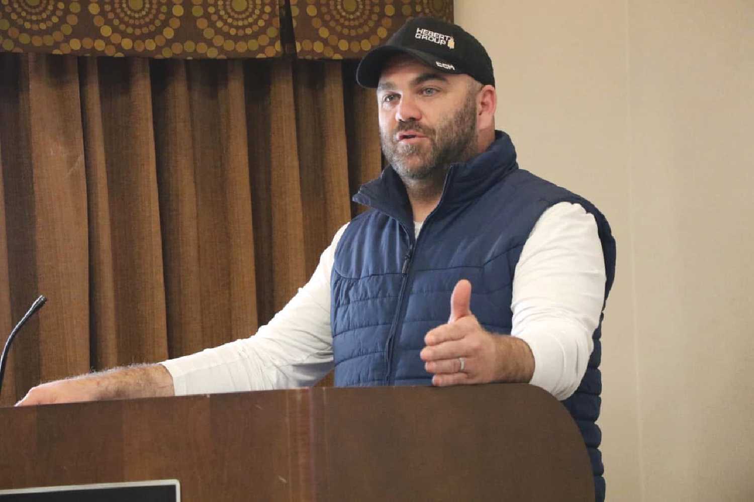 Kristjan Hebert announcing the Pipestone Legacy Community Foundation and its first project, the new rink, at the Chamber of Commerce meeting May 19.